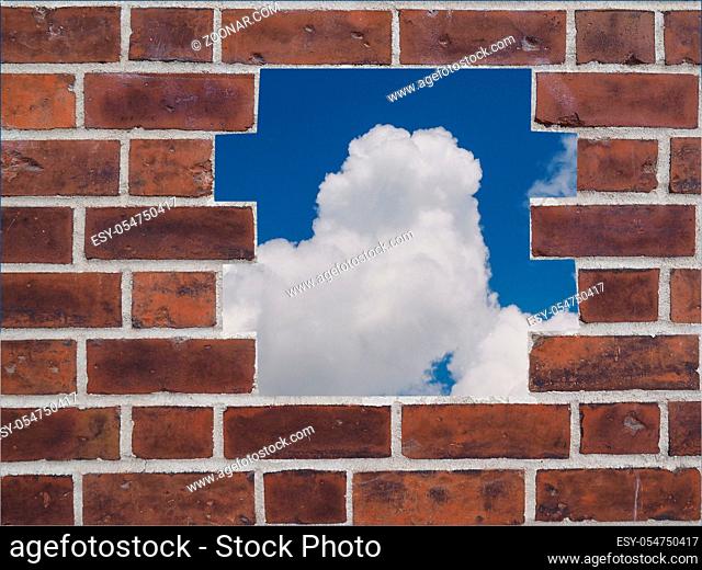 A hole in a Red brick wall with sky