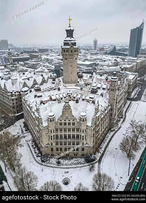 03 December 2023, Saxony, Leipzig: Snow lies on the tower and roofs of the New Town Hall. However, the winter magic is not expected to last much longer