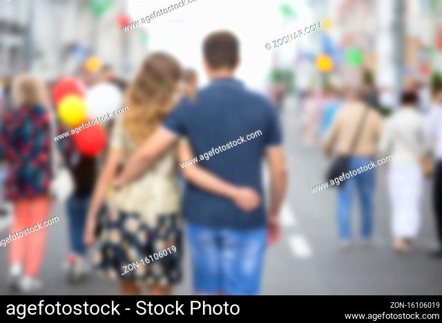 Blurred image of a hugging couple in the city