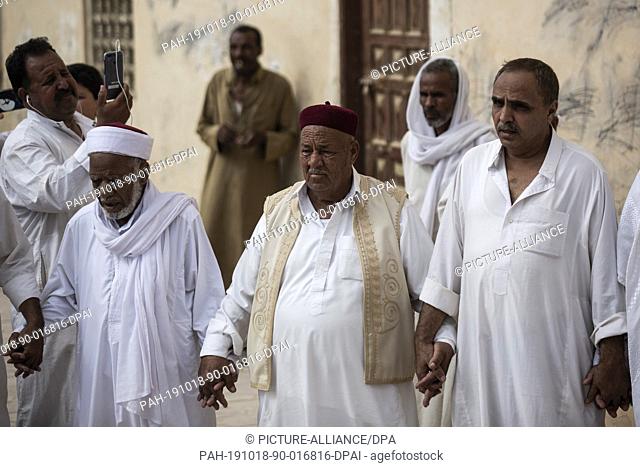 17 October 2019, Egypt, Siwa: Sheikh Abdelrahman al-Demery (C) head of al-Madania al-Shazliya Sufi order and grand chieftain of the tribes of Siwa oasis takes...