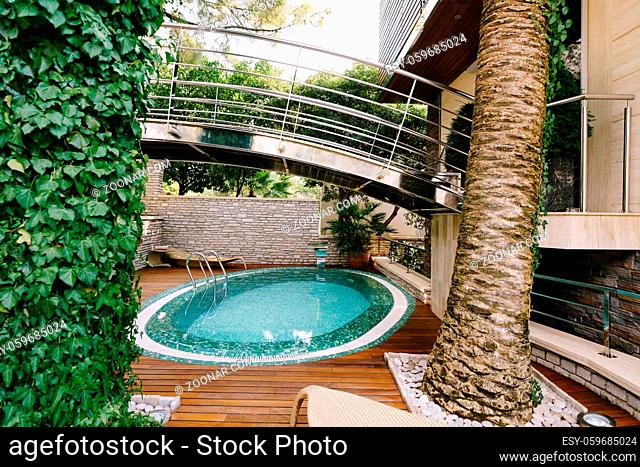 The oval turquoise swimming pool at the villa. High quality photo