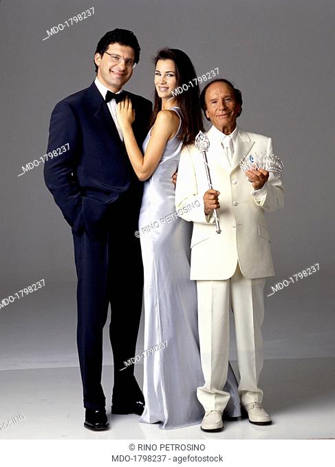 TV host of the 1999 edition of Miss Italia, Fabrizio Frizzi, is portrayed in a tuxedo, together with the winner of previous year beauty contest Gloria Bellicchi...