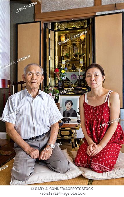 Father and daughter at family shrine in home, Tosu, Saga, Japan