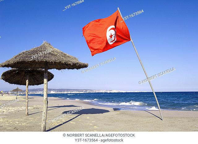 North Africa, Tunisia, Hammamet, Tunisian flag planted on the beach in Hammamet