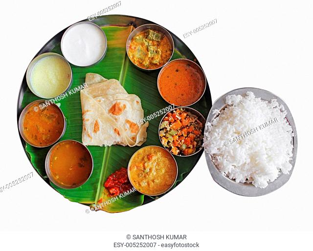South indian plate meals on banana leaf on white