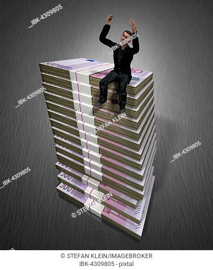 Computer graphics, man, pile, bills, bundle of banknotes, symbolic image, cheering, wealth, lottery win