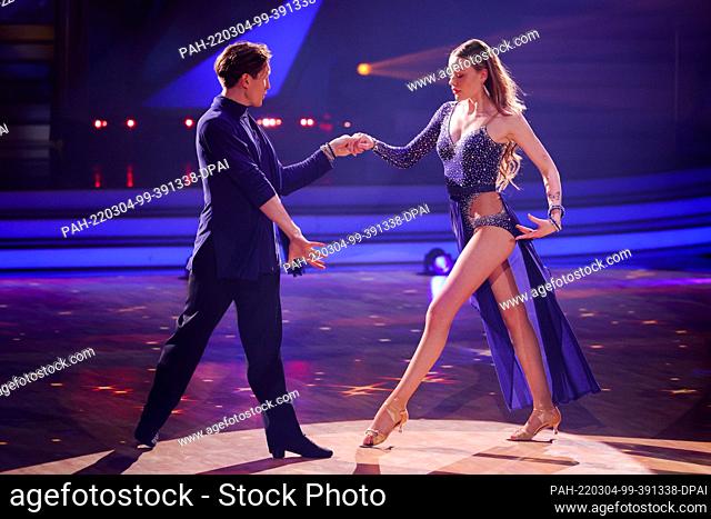 04 March 2022, North Rhine-Westphalia, Cologne: Cheyenne Ochsenknecht, influencer, and Evgeny Vinokurov, dance in the RTL dance show ""Let's Dance"" at the...