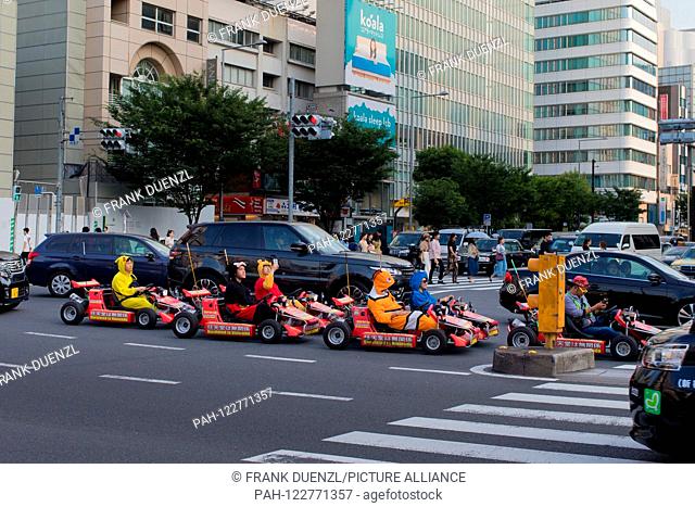 Go-karts that resemble Mario Karts, but may not be called Mario Karts, on a busy intersection in Omotesando, in June 2019. | usage worldwide