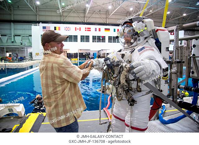 NASA astronaut Reid Wiseman, Expedition 4041 flight engineer, is pictured with a crew instructor during final preparations for a spacewalk training session in...