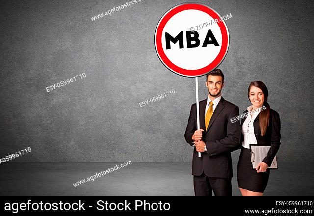 Young business person holdig traffic sign with MBA abbreviation, technology solution concept