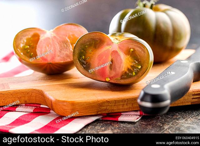 Dark brandywine tomatoes on cutting board