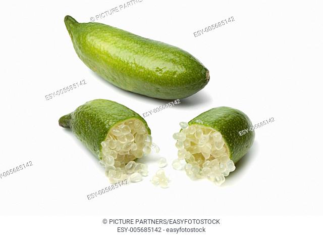 Whole and half green lime fingers on white background