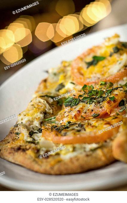 Personal size flatbread authentic margherita pizza with fresh tomatoes
