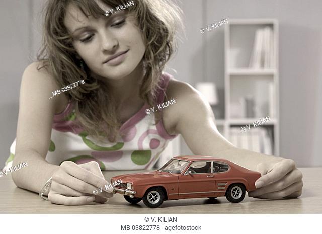 Teenager, toy car, contemplating, smiling, portrait, truncated,  Series, teenagers, girls, 15-20 years, 16 years, brunette, long-haired, curls, toy, model car