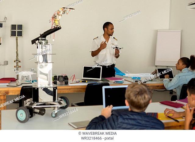 Pilot giving training about model aeroplane to students