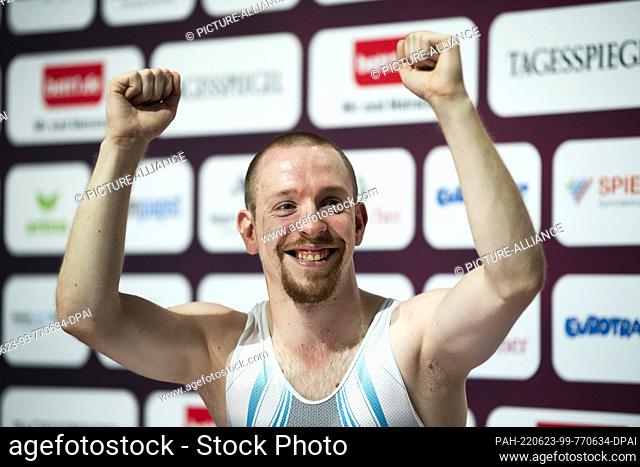 23 June 2022, Berlin: Gymnastics/Trampoline: German Championships, Fabian Vogel cheers to victory after his trampoline freestyle in the Max-Schmeling-Halle