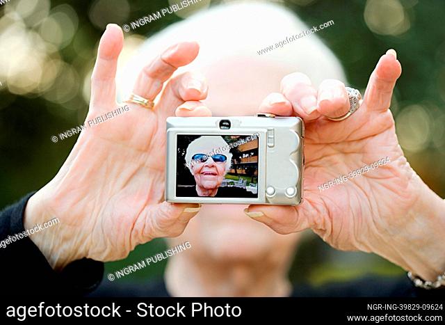 Senior woman taking a self portrait photograph