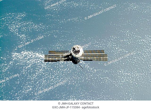 Backdropped against the blue and white Earth, the International Space Station (ISS) is seen following its undocking with the Space Shuttle Atlantis