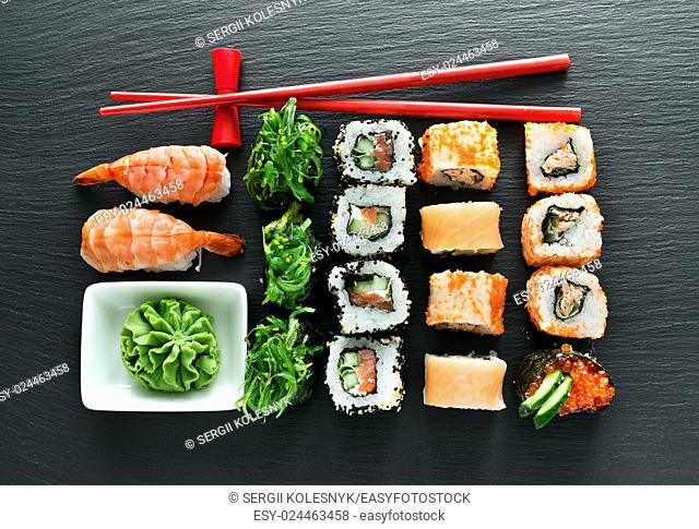 Set of sushi with wasabi and chopsticks on slate