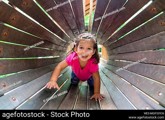 Portrait of happy little girl having fun on playground