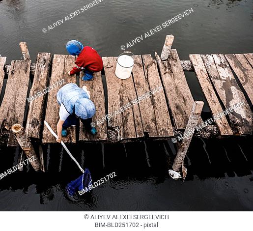 Boys playing on wooden dock