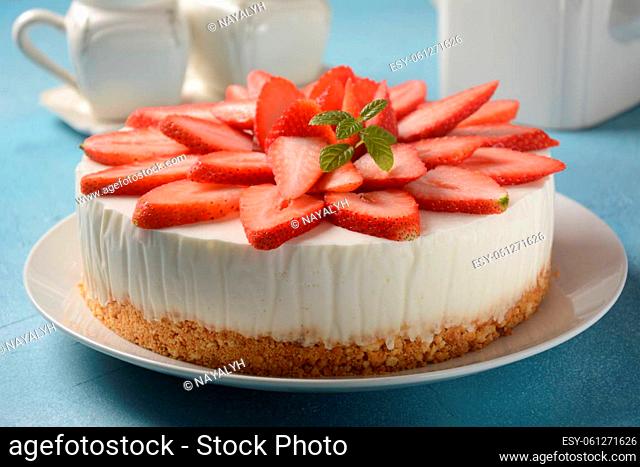 White cheese cake with strawberries garnished with mint