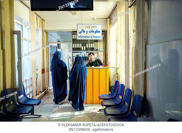 Two women in burka asking worker in Information center of Central Hospital of Afghan Red Crescent Society, Kabul, Afghanistan