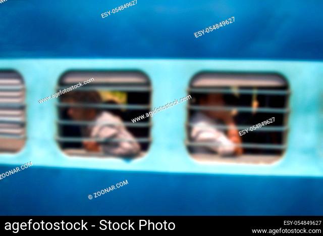Anonymous people in India in railway transport. Strong blurred people transport colored background
