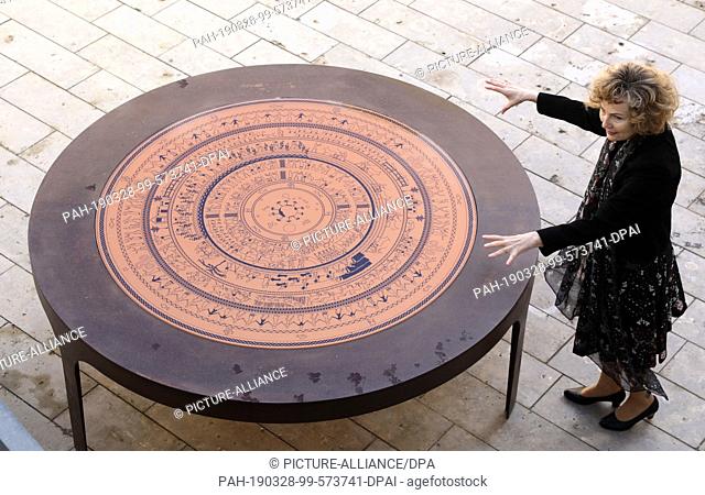 25 March 2019, Mecklenburg-Western Pomerania, Penzlin: Andrea Rudolph, director, shows the ""Shield of Achilles"", which shows the Greek world view
