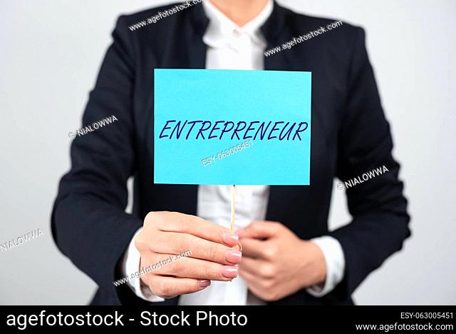 Hand writing sign Entrepreneur, Business approach one who organizes and assumes the risks of a business