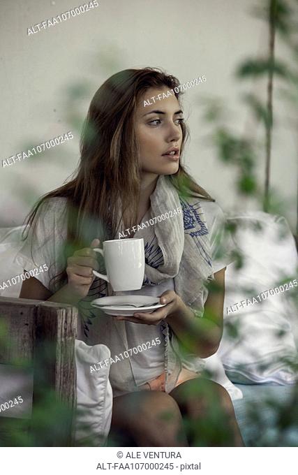 Woman enjoying hot drink outdoors