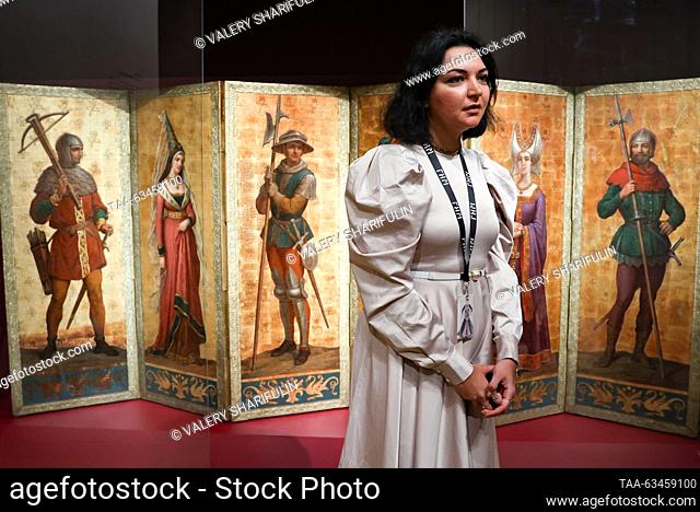 RUSSIA, MOSCOW - OCTOBER 17, 2023: A woman is seen in front of a folding screen (1830-1880) at an exhibition titled ""Peterhof