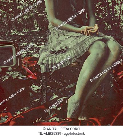 Female youth sitting alone on an old chair outdoors in woods beside an old fashioned radio