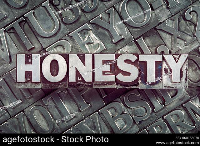honesty word concept made from metallic letterpress blocks on many letters background