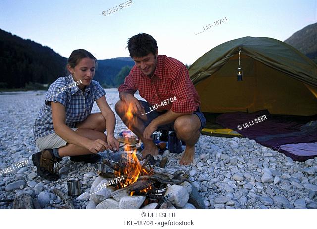 Couple at campfire, camping, Sylvenstein See, Bavaria, Germany, Europe
