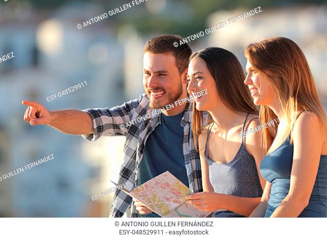 Group of happy tourists contemplating views on vacation at sunset