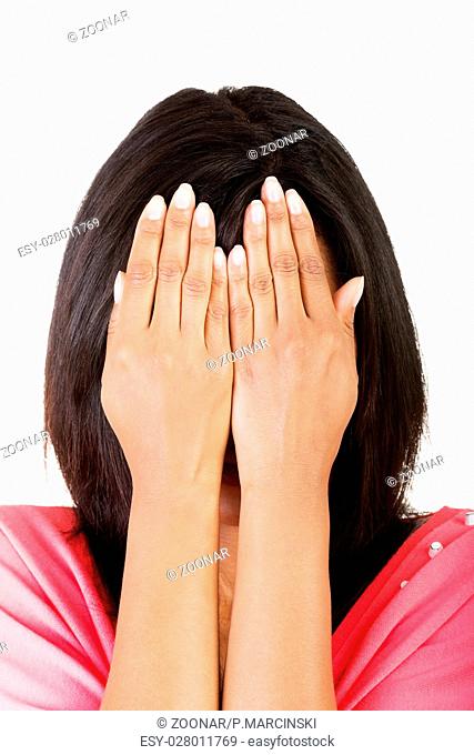 Young teen woman covering her face with hands