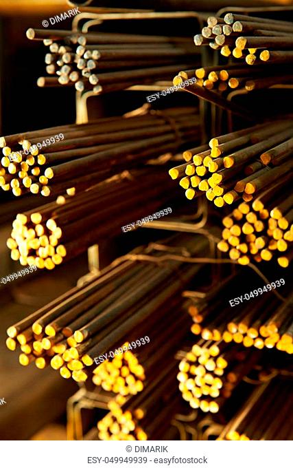 close up of yellow iron rods in storehouse