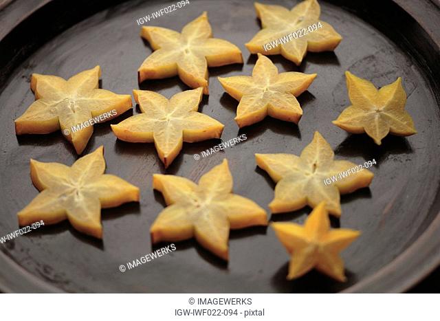 Close-up of star fruit in a pan
