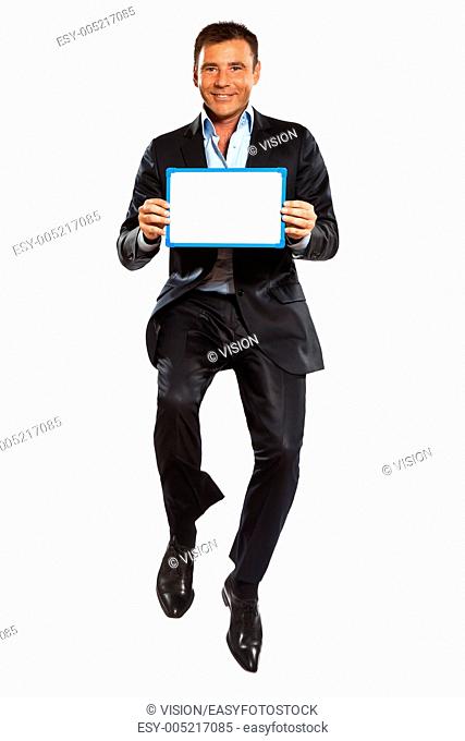one caucasian business man jumping holding showing whiteboard in studio isolated on white background