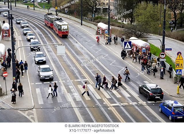 Cars, trams and people on Solidarity Avenue Aleja Solidarnosci, one of the main thoroughfares in Warsaw Poland