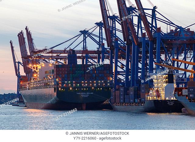 Ships at the Eurogate and Burchardkai container terminals in the port of Hamburg, Germany, at sunset