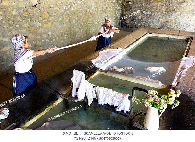Europe, France, Alpes-de-Haute-Provence (04), Valensole. Washerwoman in traditional Provencal costume