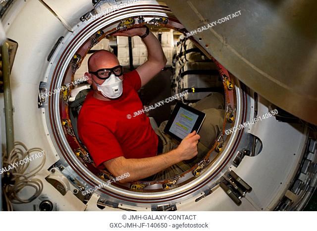 European Space Agency astronaut Alexander Gerst, Expedition 40 flight engineer, is pictured in the hatch after removing the docking mechanism of the...