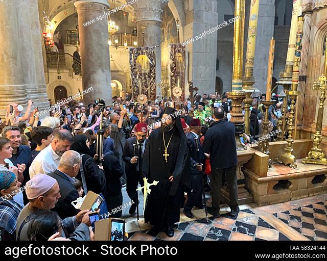 RUSSIA, JERUSALEM - APRIL 9, 2023: A Palm Sunday religious procession reaches the Church of the Holy Sepulchre to mark Christ's triumphal entry into Jerusalem