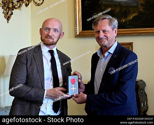 Former modern pentathlete and later coach Jan Bartu (right) receives the Order of the British Empire from the British Ambassador to the Czech Republic Matt...