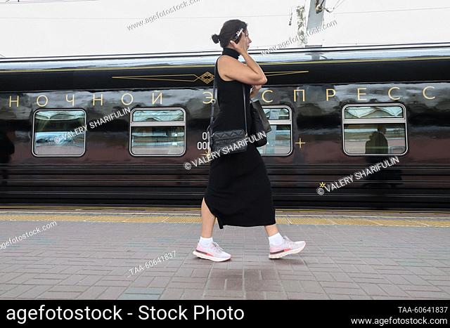 RUSSIA, MOSCOW - JULY 24, 2023: A woman walks past the Night Express train running between St Petersburg and Moscow, at Leningradsky railway station