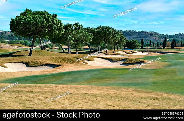 Picturesque scenery golf course green field with trees and blue lake during warm winter sunny day, meadow located in Las Colinas