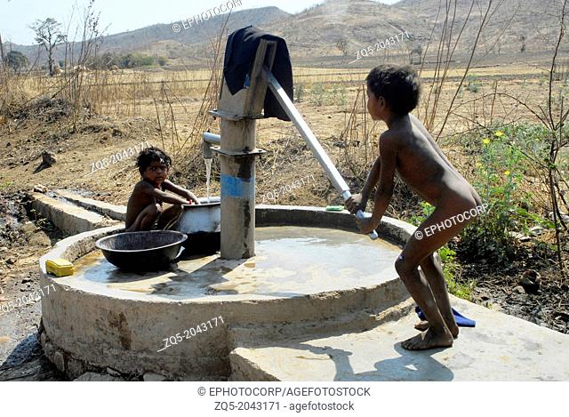 Children pumping water, Orissa, India