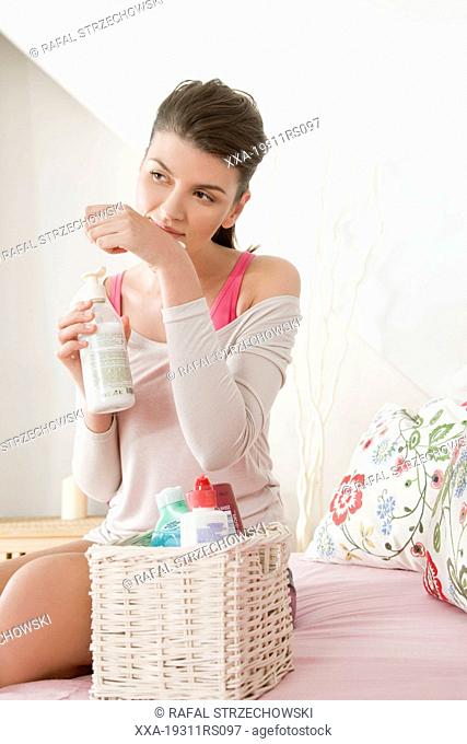 Young woman choosing body milk